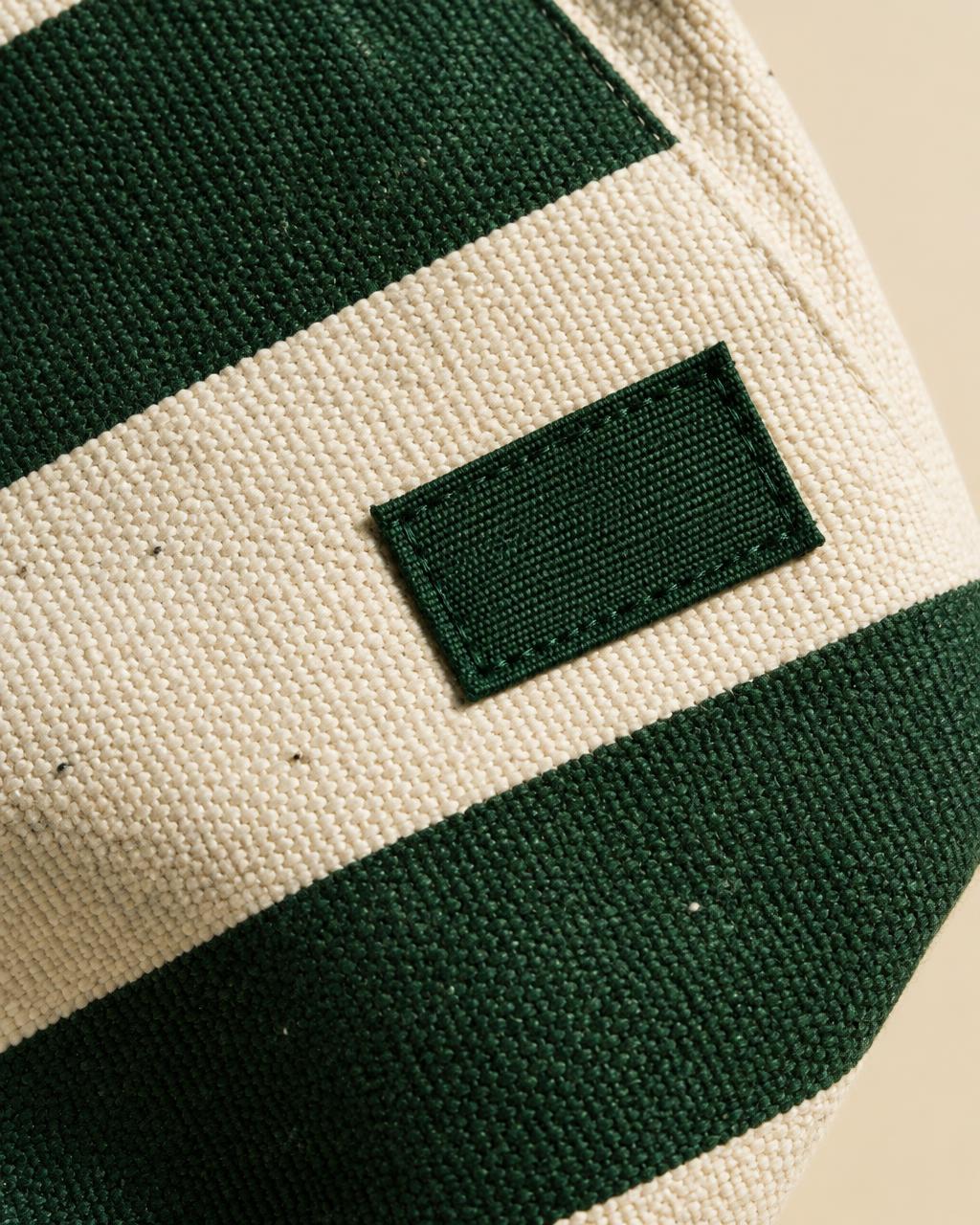 Forest green and cream woven fabric with a stitched label